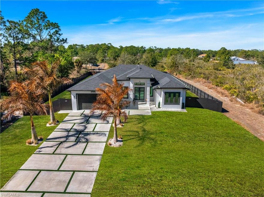 Beautiful 3-bedroom, 3-bathroom custom home on a half acre!! offering almost 2,000 SqFt of living space, designed with luxurious finishes and high-end upgrades throughout. This home features an extended and insulated 22.4' × 20' garage with an 8-ft custom insulated impact garage door and smart motor, along with aluminum bronze impact windows and doors with insulated glass for noise and heat reduction. Inside you'll find 12-ft-high custom wood kitchen and bathroom cabinets, quartz countertops, custom walk-in closets, and a designer laundry room with high cabinets, quartz, and a built-in hamper. The kitchen offers pantry pull-outs, cabinets on both sides of the island, and a dedicated mixer cabinet. All three bathrooms include full tiled walk-in showers up to 12 ft.
Enjoy outdoor living on the 37-ft insulated lanai, ready for an outdoor kitchen with water and electric in place. The exterior also includes an oversized 22-ft driveway with synthetic grass, 6-ft-wide sidewalk, wide concrete entrance, aluminum bronze gutters around entire home, irrigation system, and extended culverts for backyard access. Additional highlights include a 15ft custom wood fireplace, full house generator hookup, 30 amp RV hookup, 6ft metal fence with double gate, and a reverse osmosis potable water system. A rare opportunity to own a truly custom home with luxurious upgrades and exceptional craftsmanship in Lehigh Acres