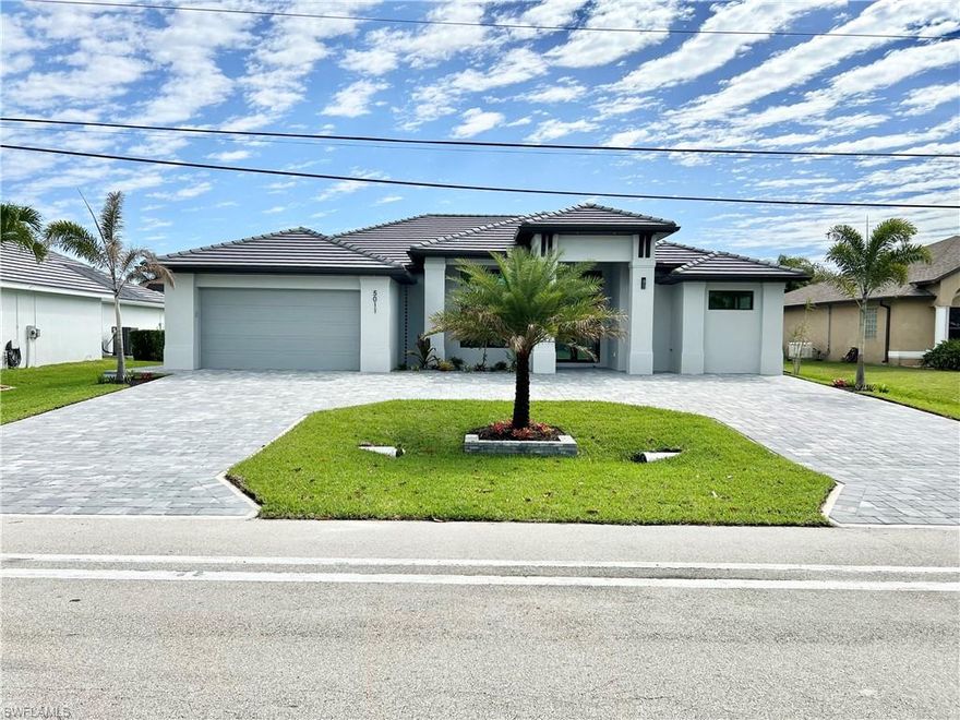 This elegant NEW CONSTRUCTION single family home sits on Agualinda Blvd , a desirable area in Cape Coral.   Upon entrance, you are warmly greeted by porcelain tile floors, fresh paint, and a bright and open floor plan seamlessly connecting the kitchen to the living room and leading to the inviting, sunny backyard. Meticulous attention to all details is presented throughout this home. Quartz countertops, customized backsplash, custom made cabinets, stainless steel appliances and much more. The master suite welcomes you through the 8' doors (found throughout the home). Large shower, His & Her Sinks with make up area and walk in closets with ventilated wood shelving, Tray Ceiling, Ceiling Fans (throughout the home). The guest bedrooms are large with tall ceilings and ample closet storage. Beautiful Brick paver circular driveway and Front Walkway! Lanai with custom pavers,  outdoor kitchen and a beautiful pool to enjoy with your family .Lush landscaping with Auto Sprinkler System. This Home is close to SHOPS, RESTAURANTS, BOATING AND THE BEST SW FLORIDA CAN OFFER.