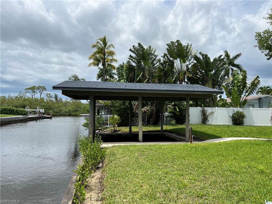 Large waterfront building site with rare cut in covered boat slip.  Close to fine dining, shopping and white sandy beaches.  120' deep with 100' of water frontage.  Quiet cul-de-sac location.