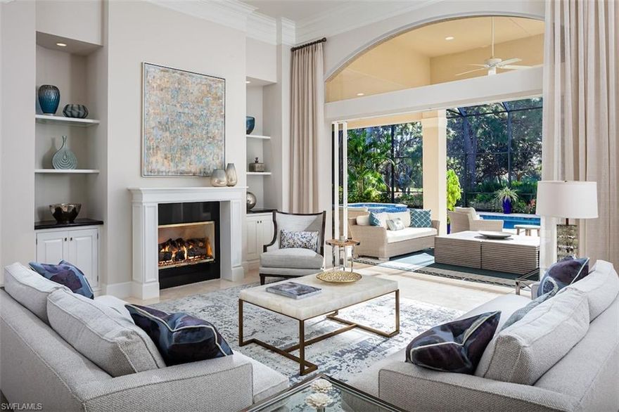 Among the finest homes ever offered in Audubon Golf & Country Club. This North Naples' estate was beautifully redesigned by coveted Collins DuPont Design Group & boasts a phenomenal golf course view with sought-after South/Southeast exposure for prime sun on the spacious pool deck. Relax & unwind in the fully screened-in pool/spa with ample living space & an outdoor kitchen. This transitional contemporary home is finely appointed with marble floors, open floor plan, & fully pocketing sliders. Gorgeous chef’s kitchen features custom cabinetry & professional grade appliances, parallel quartz islands & a gas range. Delight in 4 bedrooms/den with a large master suite, adjoined his/her bathrooms & guest suite on the first floor! The second floor includes two guest suites & bathrooms, an extra living room with morning bar & a spacious lanai to highlight the breathtaking view of the golf course. High quality furnishings available. Audubon is perfectly located 5-minutes from Mercato & world-class beaches, with gated/guarded entry, 18-hole championship Golf Course, tennis, pickleball, Bayside boardwalk, newly renovated clubhouse with dining & 2nd brand-new spectacular poolside club & café.