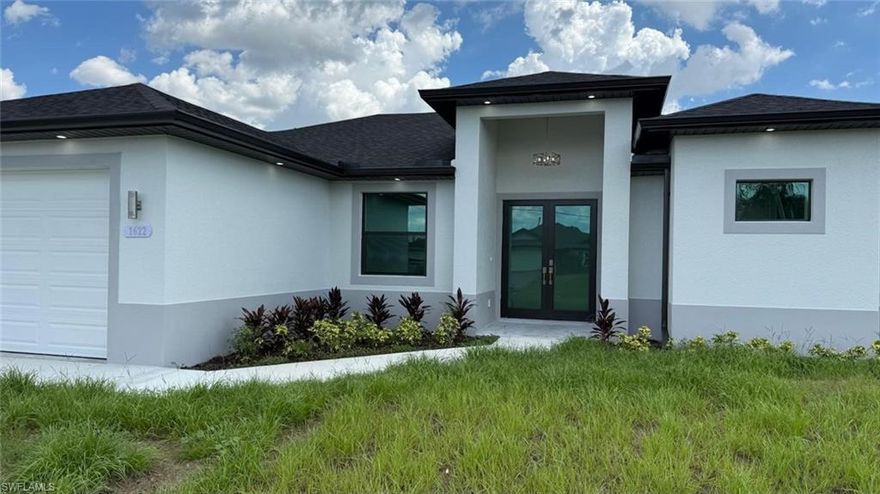 Modern Elegance and elegant Home in Cape Coral, FL! This property comes with washer and dryer, and BBQ GRILL IN THE SUMMER KITCHEN ON THE LANAI, featuring a sink and Counter. Be the first to enjoy this stunning, newly built 3-bedroom plus den, 2-bathroom home and open floor plan for modern living. The home boasts porcelain tile floors, high coffered ceilings, and a sleek design with white paint. The chef-inspired kitchen includes solid wood cabinets, stainless steel Samsung appliances, a garbage disposal, and a stylish sink. The bathrooms offer brushed nickel fixtures and tiled showers, while the master bath features a walk-in shower and freestanding bathtub. Energy-efficient with impact-resistant Low-E windows, LED lighting, ceiling fans, and a digital thermostat. The outdoor space is ideal for entertaining, with a spacious lanai. Elegant gray zebra shades provide privacy and style. Don’t miss the chance to live in a brand-new, high-end home in Cape Coral! The photos in this listing include images of the current state of this home, along with photos of a similar model that has been fully completed to show the finished result. Fenced backyard. This property is offered rented for $2200/month expiring in Nov/2026. Great for investor looking for a property already rented for fixed income.