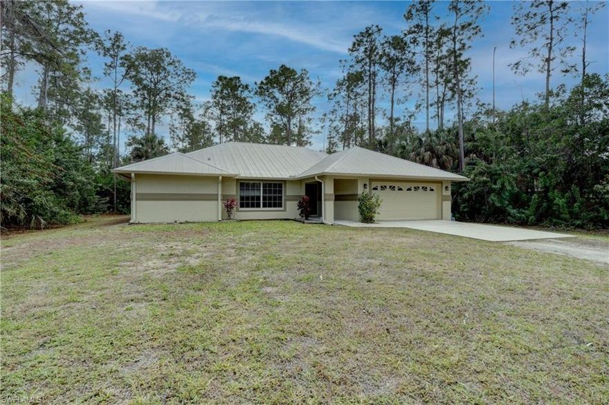 Meticulously cared for home on a gorgeous 2.5 acre lot in the desirable location of Collier Woods (west of Collier Blvd.) Nestled in a peaceful setting, enjoy your privacy while being in close proximity to all that Naples has to offer. This 3BR/2BA home is move-in ready! Highlights include a durable metal roof, new hot water heater, vaulted ceilings, updated kitchen and appliances, luxury vinyl flooring throughout, and a fresh neutral palette. There is ideal space off of the screened in lanai for a custom pool/spa and outdoor fireplace if you desire. Options are endless!
