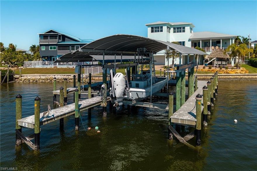 LET'S MAKE THIS DREAM HOME IN ST. JAMES CITY YOURS WITH THE MOST AMAZING VIEWS ON THE ISLAND!

This is the kind of home that leaves a lasting impression the moment you see it.

Perfectly positioned on the open waters of San Carlos Bay, this fully renovated waterfront estate offers a rare blend of deep-water Gulf access, sweeping unobstructed views, and authentic Old Florida island character. Located at the southern tip of Pine Island in St. James City, the setting feels serene, private, and timeless, while still just a short drive to Cape Coral and Fort Myers for shopping, dining, and travel convenience.

The views are simply incredible. Expansive open water stretches endlessly in front of you, with sunsets that never look the same twice. Properties with this kind of wide bay frontage are exceptionally rare in Southwest Florida, and this one delivers a truly special vantage point.

Inside, over $400,000 in renovations have been completed with a focus on quality, efficiency, and long-term peace of mind. From the new roof and full spray-foam insulation to hurricane-impact windows and doors and a whole-home generator, every detail has been carefully considered. Major systems have all been updated, including HVAC, ductwork, and instant hot water heaters, creating a home that is both comfortable and cost-efficient to own.

For boating enthusiasts, this property stands out. The dock provides protected deep-water access with no bridges, along with two brand-new boat lifts - a 6,000-pound lift and a 15,000-pound lift - making it effortless to head straight into the Gulf of Mexico at a moment’s notice.

Outdoor living feels like your own private retreat. A heated pool and spa overlook the bay, while a custom tiki hut and fully equipped outdoor kitchen create the perfect space for entertaining, relaxing, or simply enjoying the island lifestyle. Picture sunset dinners, days out on the water, and peaceful mornings just steps from the shoreline.

Inside, the home continues with a refined coastal design. Wide-plank tile flooring runs throughout, custom closets add both style and functionality, and the kitchen is truly a standout feature. Designed for both everyday living and entertaining, it includes top-of-the-line JennAir appliances, exotic granite countertops, and over $250,000 in custom cabinetry. The home is offered tastefully furnished in a Tommy Bahama style (with exclusions), making it a true turnkey opportunity.

Car enthusiasts will appreciate the oversized four-car garage with epoxy flooring, offering space for up to six vehicles along with additional storage.

This is more than just a waterfront property, it’s a rare, energy-efficient, and secure estate that combines luxury craftsmanship with one of the most sought-after waterfront settings in Southwest Florida. If you’ve been searching for wide-open water views, true Gulf access, and an island lifestyle that feels both elevated and authentic, this is it.