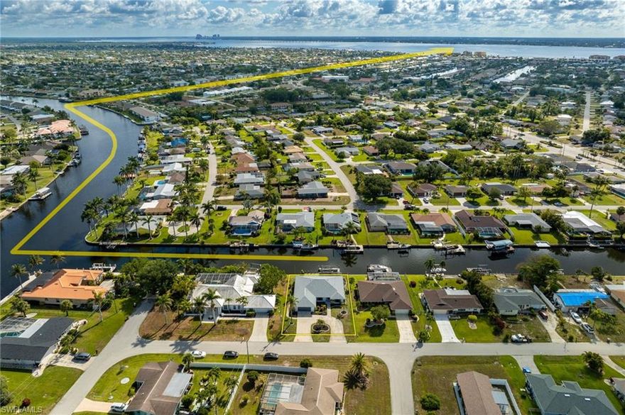 *NON-ARMS'S LENGTH TRANSACTION. NOT A COMP!* ... RARE FLEXIBILITY + PRIME LOCATION! This beautifully renovated Gulf-access home offers potential for a mother-in-law suite, a spacious master expansion, or an indoor/outdoor living transformation with its massive 600+ sq ft covered lanai. These are features most listings in this area simply can’t offer and they’re already built into the layout, ready to be realized. Located just minutes from the Caloosahatchee River and Downtown Cape Coral, placing you at the heart of everything while offering boating access to the Gulf of America. Enjoy the ultimate convenience with nearby Cape Coral Parkway and Del Prado Boulevard, home to top-rated restaurants, live music, shopping, and parks. This split-bedroom home gives you a full 3,502 sq ft of total space to live, relax, and gather. This space provides privacy and functionality, with sliding glass door access from the living room, master suite, and guest bedroom, seamlessly connecting indoor and outdoor spaces. Inside, you'll find an open floor plan with a smooth flow from the kitchen to the living area, great for every day living and entertaining. The stunning kitchen showcases quartz countertops, custom white cabinetry, stainless steel appliances, and a large island with built-in storage on both sides. Beautiful 32" x 32" tiles throughout, giving the home a clean and modern look. No detail was overlooked in this FULL RENOVATION, everything is new. NEW ROOF. NEW 200-amp electrical panel with whole house re-wire. NEW ductwork, air handler, and AC system. NEW drywall. NEW insulation. NEW doors & trim. NEW flooring. NEW tankless water heater. NEW garage door. NEW kitchen view slider. NEW kitchen and bathrooms. NEW light and fan fixtures. NEW paint (interior & exterior) NEW Italy-imported stone feature at the front entryway. NEW electrical wiring roll-down storm shutters - controlled at the touch of a switch for effortless storm protection. Additional features include vaulted ceilings, a generously sized walk-in master closet, an indoor laundry room, and a circular driveway for curb appeal and ease. Step out to an expansive under-truss lanai (approx. 12' x 59') that overlooks a sparkling pool, perfect for enjoying the true Florida lifestyle. This versatile outdoor space offers room for dining, lounging, or future expansion, and could be enclosed to create additional living square footage, ideal for a mother-in-law suite or private guest retreat. Enjoy the boater’s dream lifestyle with a 10,000 lb boat lift, wrap-around wood dock, and only 1.5 miles out to open water. Whether cruising to nearby islands or fishing the Gulf, this property delivers the best of waterfront living. Don't miss this rare opportunity with optional upgrades. Schedule your showing today!