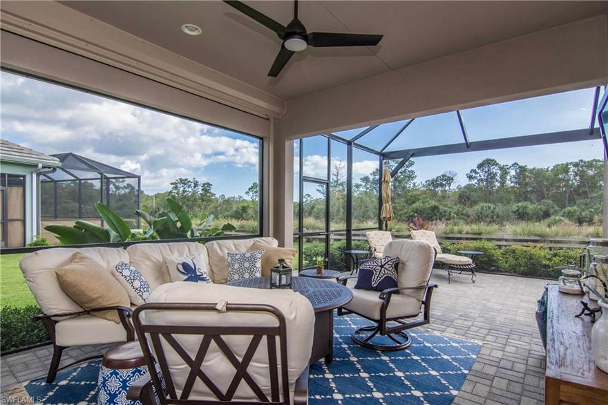 Situated on a premier lot that offers peaceful, serene natural preserve and water views. Compare to other lot locations in the community. Notice too how the home sits on a section of the street that starts to bend, this provides more space between you and your neighbors and brings in more natural light inside. Coastal interior, white kitchen cabinets and sparkling quartz counter tops with neutral 18" floor tile set on the diagonal. Eight foot shaker style doors, volume and tray ceilings range from 10-11 feet adding to the overall open airy look and feel of the home. Popular plan with the island kitchen opening up to the dining and living rooms. Split bedroom floor plan. The den serves as an extra guest room when needed. Extra-large Picture-Window screened lanai, ample sitting and outdoor dining space with sunset views. Note the added value in the Lights & Fans, Electric Storm Shades and Plantation Shutters. See the photos.  The Isles offers a luxurious lifestyle with resort style amenities, community and lap pools, state of the art fitness facility offering classes, sauna, tennis, pickleball, kayaks and paddle boards.  On the water's edge, visit the New Overlook Bar & Grill!