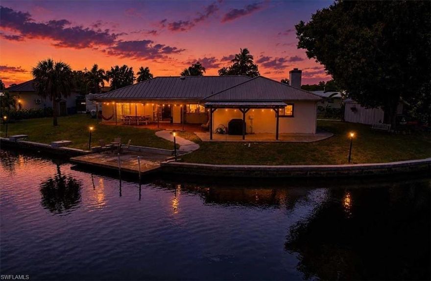 Welcome to paradise in the highly sought-after Belle Aire Lagoon, where waterfront living, space, and freedom come together in one exceptional property. Perfectly positioned on a quiet cul-de-sac, this Gulf-access canal home offers the largest floor plan and best value in the community, making it a rare opportunity for boaters, families, and Florida lifestyle enthusiasts alike. Situated on an oversized .31-acre lot, this solid concrete block residence features 2,474 square feet of living space and nearly 3,000 total square feet designed for comfort, entertaining, and enjoying the waterfront lifestyle. Step outside to your private dock and boat lift with Gulf access, ideal for boating, fishing, and sunset cruises right from your backyard. Inside, the home has been beautifully updated with all new tile flooring throughout, modernized kitchen and baths, and an open-concept layout filled with natural light. The spacious kitchen is a true centerpiece, featuring wood cabinetry, quartz countertops, stainless steel appliances, and dual breakfast bars perfect for entertaining or casual family gatherings. Multiple living spaces include both formal living and family rooms, offering flexibility for everyday living and hosting guests. The oversized primary suite provides a private retreat with generous space to unwind and a large en-suite featuring two walk-in closets. With 4 bedrooms and 2.5 bathrooms, there is plenty of room for family and visitors alike. Additional highlights include, a durable metal roof, an expansive covered patio overlooking the canal, attached 2-car garage, large circular driveway with abundant parking, and no HOA and no community restrictions for boats, RVs, or recreational vehicles. Centrally located near downtown Fort Myers, dining, shopping, entertainment, and waterfront attractions. Whether you are searching for a full-time residence, seasonal retreat, or waterfront investment opportunity, this property delivers the best of Southwest Florida living with unmatched space, updates, and boating access. Schedule your private showing today and experience everything this exceptional Gulf-access home has to offer.