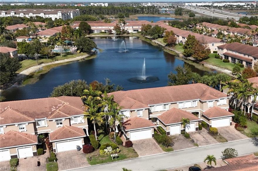 Welcome to this oversized end-unit residence, perfectly positioned on one of the best lots in the community, offering tranquil water views of a serene pond with three fountains. Featuring 3 bedrooms, 2.5 bathrooms, and a 2-car attached garage, this home seamlessly blends comfort, style, and an exceptional location.

Inside, you’ll find a fresh, move-in-ready feel with updated paint and carpet (approximately one year old) and new appliances. Furniture is included, with most pieces nearly brand new, allowing for an effortless transition into the Florida lifestyle. The home also offers custom-made accordion hurricane shutters for added peace of mind.

The garage is thoughtfully designed with three overhead storage bins, two ceiling-mounted bicycle/kayak hangers, and wall organization systems on both side walls, providing excellent storage and functionality.

Outdoor living is a standout feature, highlighted by an oversized front paver patio and a side patio ideal for grilling, all complemented by peaceful water views that create a relaxing backdrop for everyday living or entertaining.

Ideally located just 3.5 miles from the airport, and close to Florida Gulf Coast University, beautiful Gulf beaches, shopping, dining, and everyday conveniences, this home offers both privacy and accessibility.

Whether you’re enjoying coffee on the lanai overlooking the fountains or heading out to nearby beaches and amenities, this furniture-included property truly delivers the best of Southwest Florida living.