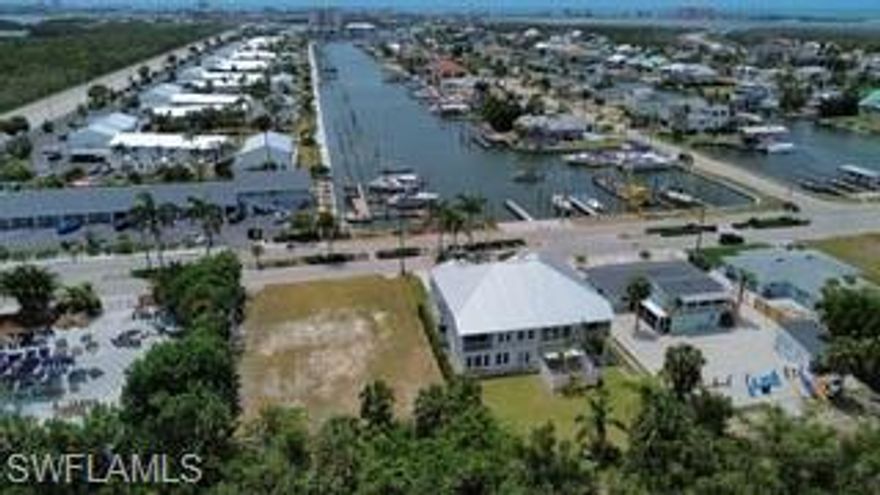 Rare opportunity to own a duplex-zoned waterfront lot in the highly desirable Siesta Isles boating community, which allows non-restricted vacation rentals. There is no HOA, allowing you the freedom to enjoy your property to the fullest without restrictive rules or fees. Enjoy quick access to Fort Myers Beach by land or reach the Gulf of Mexico by boat in minutes. Siesta Isles offers deep-water, unrestricted boating with no bridges, making it ideal for serious boaters.
The property features a newly constructed 80’ finger pier dock with nearly 200’ of total dockage. Dock amenities include two power pedestals with 50/30/20 amp service and water.  Bonus the dock is currently income producing, there are three vessels that are currently leasing the dock.

A pre-approved building permit for a duplex is in place, with building plans and pro forma included in the sale and available upon request. This is an exceptional opportunity for development, short-term rental income, or a waterfront investment in one of the area’s most sought-after neighborhoods.