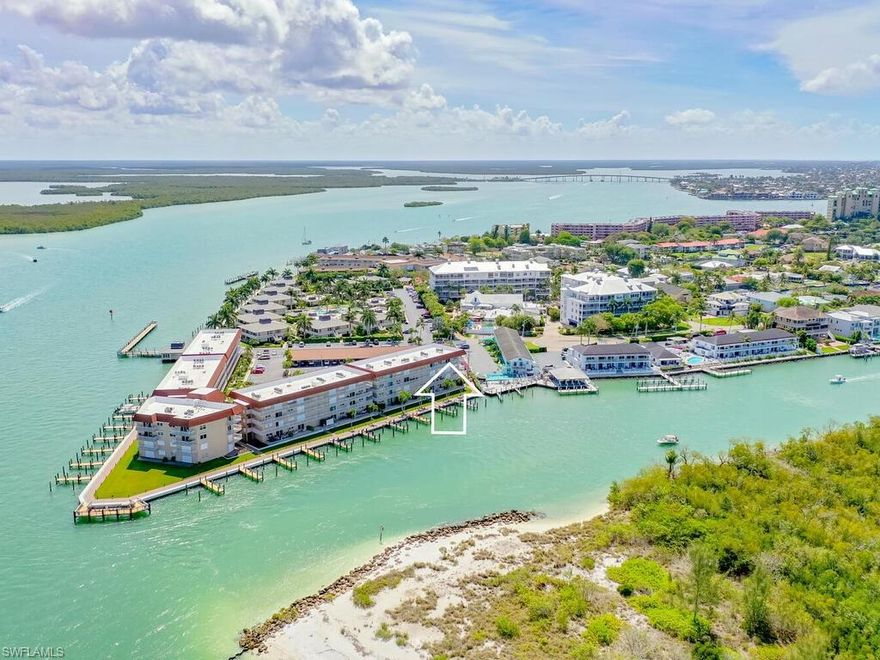 Views from the balcony you cannot unsee!!  This impeccably remodeled, top floor, end unit has an open kitchen with granite counters, stone backsplash, custom cabinetry, and stainless -steel appliances.  Superbly appointed throughout, with plantain shutters, crowned molding, designer lighting, and stone tile.  Being offered turnkey furnished.  The beautiful, breath-taking views from this west facing balcony overlooking the Collier Creek, Marco River, and the Gulf of Mexico will have you never wanting to leave.  Relax the day away watching the dolphins, manatees, birds, and boats cruise by.  Fish to your heart’s content from the west facing fishing/observation pier at this sought-after fishing spot.  Leaving from your direct access boat slip, the Gulf of Mexico is your new backyard.  Beaches, shelling, and open water are minutes away.  Comes with a desired covered parking spot and boat slip.  Close to shopping, dining, and entertainment, Ville de Marco West is where the dolphin play.  Spectacular condo!  Spectacular views!  Spectacular location!  Prepare for winter now!!