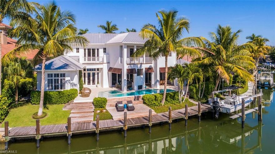 H.15340 Flawless…a captivating coastal sanctuary that challenges the status quo. This 5-bedroom residence designed exclusively by Falconer Jones capitalizes on the premium south-facing deep-water location in Royal Harbor. Surrounded by lush landscaping this home opens wide to 105 ft of waterfront and huge views. Entertain guests in your expansive outdoor great room, complete with a fireplace, automated screens, alfresco kitchen with Wolf grill and a large pool & spa. From your 85 ft Ipe dock with boat lift, appreciate quick, no-bridge access to the Gulf. With relaxed living in mind, the design exudes character with organic elements throughout. Pocketing sliders blur the lines between indoors and out. Find the serene master bedroom and guest bedroom/office on the ground floor. Upstairs boasts 3 more bedrooms and a huge family room with waterfront balcony.  Superior features including full concrete structure, standing seam metal roof, wide-plank oak wood floors, Sub-zero & Wolf appliances, home automation, impact windows & doors & a fully equipped catering kitchen.  This is the home you’ve dreamed about…the home you’ve admired. Now it can be yours.