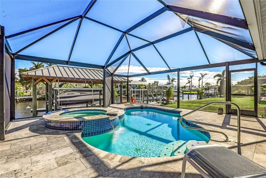 H8092- Much potential will be found at this fantastic waterfront location. Situated on one of the widest direct Gulf access canals in the area. Featuring a 100 X 125 lot with concrete seawall, metal roof boathouse with lift and a separate platform lift for personal water craft. Also, the expansive lanai and pool deck were just refurbished with travertine stone and features a picture window pool cage with freeform swimming pool and built-in hot tub/spa. The lanai is so inviting it's perfect for entertaining. With nearly 2600 square feet under air this spacious home offers 3 bedrooms, 3 full baths, 3 car garage and an all new roof, electric service and new central air. The home has been mitigated from the hurricane flood, a general contractor has been hired and building permits and renovations have begun. Price is subject to change as work is completed and is based on it's current "as is" condition.