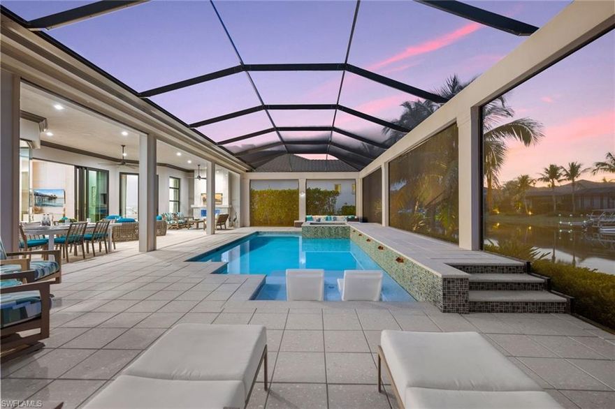 Welcome to this stunning single-family home in the exclusive Salerno neighborhood of Miromar Lakes. This luxurious 4-bedroom, 3.5-bathroom residence boasts an open-concept design with a spacious great room, perfect for entertaining and family gatherings. The chef-inspired kitchen is a dream, featuring top-of-the-line appliances, a large island, and custom cabinetry—ideal for preparing meals and creating lasting memories.

Enjoy the best of indoor-outdoor living with an expansive covered lanai that features a fully equipped outdoor kitchen and a cozy outdoor fireplace, all with a breathtaking western exposure that provides spectacular sunsets over the lake. For added privacy and tranquility, the home also offers a charming side yard with a built-in gas fire pit, perfect for cozy evenings under the stars.

Miromar Lakes is a world-renowned community offering unparalleled amenities, including a 700-acre freshwater lake for boating, fishing, and water sports, an award-winning beach club, a championship golf course, a luxurious spa, and fine dining options. Residents also have access to state-of-the-art fitness centers, tennis courts, pickleball courts and a vibrant social calendar that ensures there's always something exciting to enjoy.

This exceptional home offers a perfect combination of privacy, luxury, and world-class amenities. Don’t miss the opportunity to make it your own!