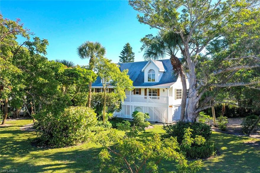 Peacefulness and tranquility come to mind when you drive up to this large, lake front home. This southern style home has numerous porches, both open and screened to enjoy the mature, tropical landscaping and island wildlife.  Lovely wood floors throughout, with a two story ceiling in the living area with many large windows making the entire house light and bright. The master bedroom has a newly remodeled bath with sliders directly out to the large screened porch overlooking the large pool, spa and lake beyond. 
2nd guest bedroom is adjacent to the hall bath with quick access.  Plantation shutters throughout, painted in soft, soothing colors, giving this home a gracious southern feel.  Large loft/bedroom/office upstairs with private bath and the bonus of another open porch for relaxing.  This warm inviting home is being sold completely furnished with exceptions of artwork and a few personal items.