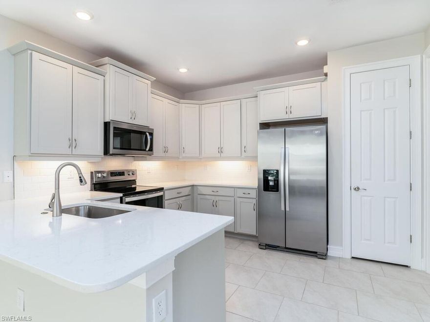 MOTIVATED SELLER!. Welcome home to this pristine & beautiful attached Villa in Enbrook. A new construction community is convenient to both Naples and Marco Island. This Villa boasts 2 Bedrooms PLUS a den/study allowing for plenty of space for you & your family. There is a generous size kitchen & dining area along with a spacious living room with access to the screened lanai. The master bedroom has its own en-suite bathroom and a walk-in closet. The 2nd bedroom is right next to the guest bath affording your guests privacy.  This unit has ceiling fans with remote controls in each bedroom, den & living room.  Quality window treatments have also been installed on all windows. There is a 2 car attached garage, with access directly into the home, a convenient laundry room off the kitchen, as well as a pantry in the kitchen, a keyless entry & smart home panel in the entry area. Enbrook is a gated community with a clubhouse including a catering kitchen, gym, pool & multiple pickleball courts. Enbrook is situated off of Manatee Rd providing several shopping, dining & beach options just minutes away. As a special bonus, this home has private lanai views as it backs up to the desirable preservation land section of the community.