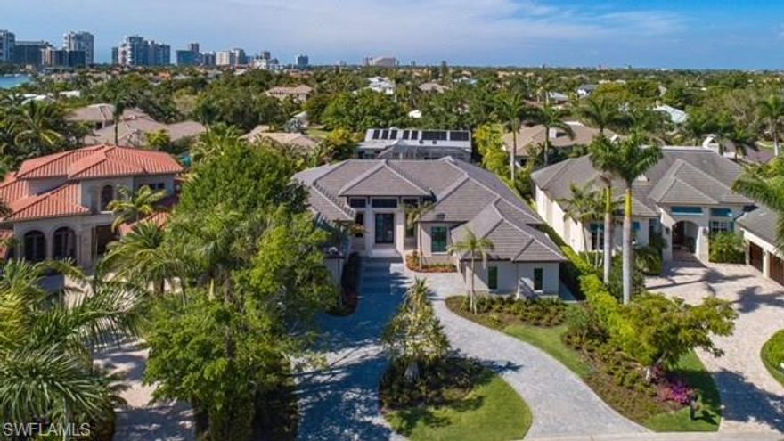 2018 CONSTRUCTION -COASTAL CONTEMPORARY HOME 4 bedrooms, 4 full and 2 half baths, Den and Club Rooms, 3 car garage,  wine room, open kitchen over dining and living area plus incredible outdoor pool, wood deck, outdoor fireplace and more! -  FURNISHED. Prestigious Moorings address. Located minutes from beaches of the private Moorings Beach Park. Designed by award-winning architect, Richard Guzman.  ONE-STORY home features exceptional interior features include custom cabinetry and built-ins, rich wide planked wood Oak flooring, superb ceiling details, spa-inspired baths, a professional grade gourmet kitchen with oversized island and gas Thermador appliances.  Impeccable detailing and architectural elements combine with a soothing pallet of neutral shades to provide a one of a kind living experience. Four bedrooms have all en suite baths with generous closets. (All guest suites fit King beds!)  Outdoor living space includes: gas heated pool and spa, separate outdoor kitchen and bath , a loggia area with a fireplace wonderful deck area for entertaining and more.