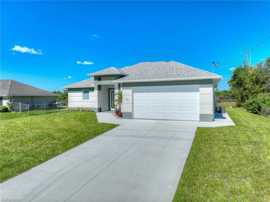 Welcome to this beautifully ready to move in 3-bedroom, 2-bathroom home with a spacious den, located in the sought-after Southwood Lehigh Acres neighborhood. This brand-new construction boasts a perfect blend of modern design and functional features, ideal for comfortable living. As you enter, you’re greeted by high tray ceilings and the sleek LVP flooring that flows throughout the open-concept layout, highlighting the home’s spaciousness and bright, airy feel. The heart of the home features a gourmet kitchen with gorgeous quartz countertops and backsplash, and a large island perfect for cooking and entertaining. High-end stainless steel appliances complete the space, making it a dream kitchen. The living area is flooded with natural light through impact doors and windows, offering both beauty and peace of mind. Elegant light fixtures and charming barn doors add a touch of sophistication to every room. The master suite is a true retreat with an en-suite bath featuring walk-in shower with glass doors, and plenty of closet space. The additional bedrooms are well-sized and share a beautifully designed second bathroom. Enjoy the convenience of a two-car garage and modern finishes throughout, making this home the perfect choice for the new owner. NO HOA and NO FLOOD INSURANCE. Don’t miss the opportunity to make this home your own! Schedule a tour today to experience all that this stunning new construction has to offer.