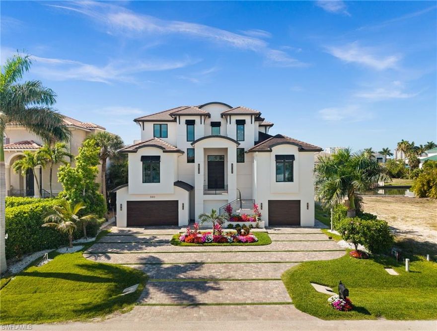 Completely reimagined and masterfully curated, this exceptional waterfront residence offers approximately 4,350 total square feet of refined living space, featuring 5 bedrooms, 6 bathrooms, and an expansive 8-car garage designed for car enthusiasts and elevated storage. Designed with a focus on modern elegance, seamless indoor-outdoor living, and full smart home integration, every detail has been thoughtfully elevated to create a sophisticated yet effortless lifestyle.

The home features a full Savant smart system controlling audio, lighting, climate, security, and entertainment, along with integrated interior and exterior speakers and oversized upgraded TVs throughout. Custom design elements define the interiors, including bespoke closets in every room, a striking fireplace feature wall, a designer wet bar in the upper-level living area, and an interior dry bar with a custom wine room. The primary suite is enhanced by a stunning custom focal wall, creating a refined and inviting retreat.

The kitchen and bathrooms have been beautifully upgraded with new countertops, high-end fixtures, and modern finishes. Four fully renovated bathrooms feature custom tile and glass enclosures, including a spa-inspired primary bath with a smart toilet. Rich hardwood flooring extends throughout the upper level, adding warmth and continuity.

Outdoor living is designed as a true extension of the home, featuring a fully equipped outdoor kitchen with Lynx professional grill, dual burner, refrigeration, and sink, along with a second-floor outdoor kitchen redesigned with new tile finishes. The pool and spa have been completely transformed with new tile, Pebble-Tech finish, custom coping, cascading water features, ambient lighting, built-in seating, and an expanded layout that creates a private resort-style setting. A private sauna located adjacent to the pool bath enhances the outdoor wellness experience.

Additional enhancements include comprehensive landscape lighting, a custom flood protection system, and a whole-house generator providing comfort and peace of mind. The home is offered fully furnished with high-end interior and exterior pieces, delivering a true turnkey experience.

Enjoy effortless waterfront living with private dock access, ideal for boating enthusiasts with direct Gulf access just minutes away. From peaceful mornings overlooking the water to vibrant evenings of entertaining under the Naples sky, this residence offers a lifestyle defined by ease, elegance, and connection to the coast.

Ideally located in the Vanderbilt Beach area within the Connors waterfront community, near world-class beaches, dining, and premier golf, this residence defines modern waterfront luxury in one of Naples’ most desirable locations.