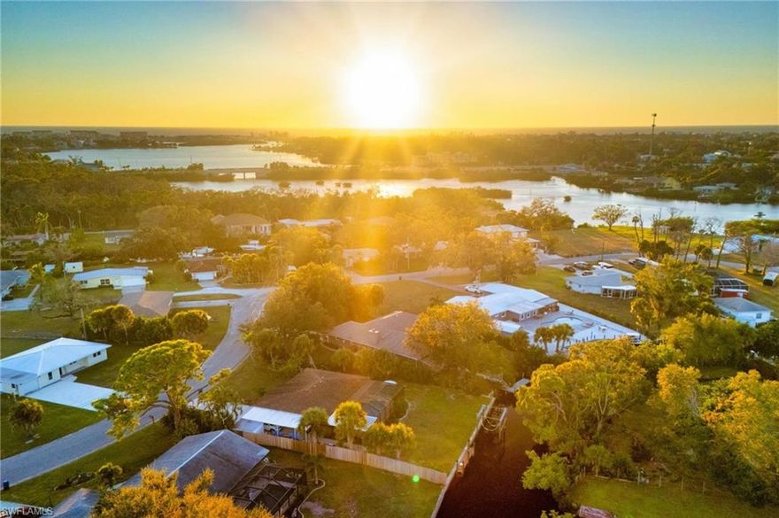 This special, one of a kind home has quick access to Dona Bay and then the beautiful ocean waters of the Gulf. This home is exceptionally elevated at more than 11 feet, keeping it high and dry and solid through storm season with zero flooding over the years. The inviting layout features 3 bedrooms, 3 bathrooms and a heated saltwater pool on a spacious, nearly half-acre lot shaded by stunning mature oaks and fruit trees. Interior highlights include fresh, light and bright paint, rich wood-look plank floors, vaulted ceilings, and a cozy woodburning indoor fireplace. The fully remodeled gourmet kitchen includes gorgeous Quartzite countertops, stainless appliances, solid-wood cabinets, built-in espresso maker, and a charming custom wine room for the wine connoisseur. Views of the relaxing pool deck with an outdoor kitchen from nearly every angle. The primary suite features pool access, custom walk-in closets, and a spa-like ensuite bath with a beautiful Spanish marble soaker tub, dual sinks and tiled shower. The split bedroom floorplan affords privacy and convenience for the second and third bedrooms, and the third bedroom features a private ensuite bathroom and pool access. The full guest bathroom also features pool access. The outdoor oasis includes a caged lanai with a saltwater, heated pool, outdoor kitchen, and a unique custom-built fire pit area. Follow the path to the dock and seawall, and imagine your own boat waiting to take you out for a fun day on the Gulf. Oversized 2-car garage has epoxy floors and upgraded modern storage cabinets with a tool bench. Truly a unique and charming waterfront escape located conveniently near historic downtown Venice, Venice Beach, Nokomis Beach, and Casey Key. Travel a short distance north for all of the amenities of Sarasota, including an exciting downtown district, Siesta Key Beach, performing arts venues, and luxury dining and shopping.
