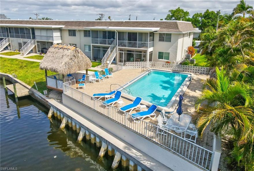 TURNKEY OPPORTUNITY! EVERYTHING STAYS! Welcome to effortless Southwest Florida living in this beautifully appointed GULF ACCESS waterfront condo located in highly desirable SE Cape Coral, just seconds from the heart of Downtown Cape Coral. Enjoy being moments away from some of the area’s best dining, shopping, nightlife, and entertainment, including brick-paver bar hopping, bike nights, art walks, the popular Saturday Farmers Market, and the widely renowned Red, White & BOOM celebration held annually near the Cape Coral Bridge. Offering a rare combination of style, convenience, and value, this residence is ideal as a seasonal retreat, full-time residence, or investment opportunity with a minimum 2-month leasing policy and a relaxed, investor-friendly condo association experience. Step inside to discover a true turnkey opportunity being offered with no exclusions. Tasteful updates throughout include granite countertops, upgraded tile flooring throughout the entire unit (no carpet!), fresh drywall and paint work, and a beautifully updated primary suite featuring a remodeled shower, elevated granite vanity top, and additional cabinetry for enhanced storage. The kitchen is both functional and inviting, complete with a wine fridge and ample prep space perfect for entertaining guests. One of the standout features of this residence is the exceptional amount of storage rarely found in condo living. In addition to a private exterior storage closet, the unit features a spacious under-air storage room conveniently located between the bedrooms, providing abundant tucked-away space for seasonal items, hobbies, or everyday essentials. An in-residence laundry area adds even more convenience to daily living. Peace of mind comes easy with a NEWER WATER HEATER (2025) and a washer that is only approximately one year old. Step out onto the tiled lanai and unwind while overlooking the beautifully maintained community grounds and enjoying the laid-back waterfront lifestyle Southwest Florida is known for. This meticulously maintained community offers an impressive list of amenities and inclusions, with the association covering covered parking (one designated space plus ample guest parking) pest control, lawn maintenance, water, pool care, flood insurance, and exterior maintenance. Residents also enjoy a HEATED community pool with a resurfaced pool deck completed in 2024, along with a charming covered tiki sitting area by the water — the perfect place to relax and soak in the Florida sunshine. If you’ve been searching for a low-maintenance waterfront Cape Coral property with stylish upgrades, outstanding amenities, exceptional storage, and unbeatable proximity to Downtown Cape Coral, this is one opportunity you will not want to miss. Schedule your private showing today.