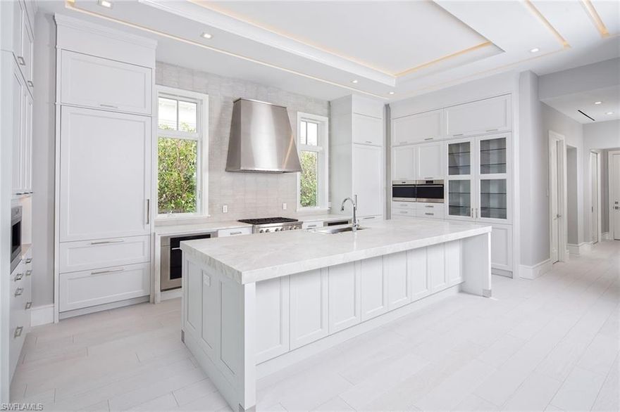 Slated for completion in the fall of 2020, this thoughtfully designed plan offers luxurious amenities and a private mangrove view. The first level sprawls over 4,500 sq. ft. of living space and showcases pristine details emulating the white sand of the Gulf Coast. With its mix of sophistication and charisma, the streamlined wood slatted ceiling treatments, minimalist recessed lighting, clean baseboards, glass rail staircase and incredible stone and tile selections will please nearly every design taste. The expansive outdoor area both covered and uncovered, perfectly surrounds the vanishing edge pool which seamlessly disappears into the sparkling bay waters. Within close proximity to the Port Royal Club, this brand new home will make the ideal retreat for full or part-time residents