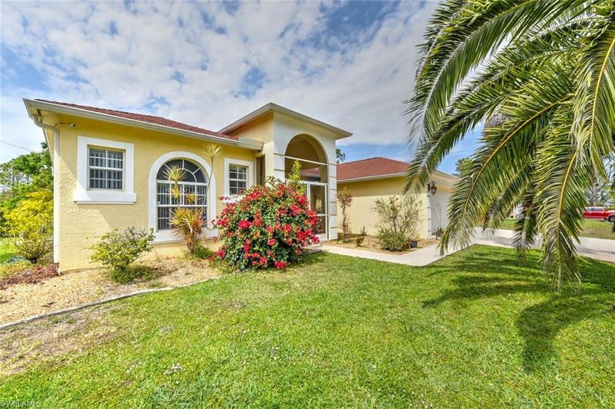 Welcome to your dream home, where luxury, comfort and fun collide! This is a stunning property located in the highly coveted country club estates subdivision in Lehigh Acres, on spacious half-acre lot on a quiet dead-end street. Inside, you'll find and open spacious split floor plan with amazing high ceilings, three bedrooms and three bathrooms, including a split primary bathroom with a garden tub, walk-in shower and dual closets. The guest room with an ensuite is perfect for visiting friends and family. This home also features a large laundry room with built-in cabinets and a wash tub and a three-car garage with plenty of shelving for convenient living. For added peace of mind, you'll enjoy keyless entry and a top-of-the-line alarm system. The outdoor space is the real star of the show, with a heated pool and spa with a huge lanai that's perfect for outdoor entertaining. Enjoy the sprinkler system to keep your lawn green and lush and all the fun amenities this home has to offer. Don't wait to start living your best life! Book your viewing today and make this your dream home.