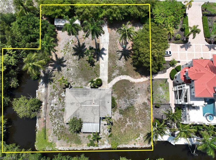 Presenting a Bonita Beach direct river access .7 acres corner lot. This TFC2 zoned property features just under 300' of navigable waterfront with basin. Imperial River Road is one of the best streets within Imperial Shores with homes valued up to $5+ million.  This location is just off the river on a quiet tree lined street that will be perfect for construction of one or possibly two attached residences. Property includes gated drive and a water view that features no neighboring homes across the water. There are mature palm trees and landscaping buffer that provides a private oasis for your new home(s).  This property, which includes water basin parcel, totals 29,884 square feet  This property is within walking or biking distance to beautiful Bonita Beach and is just a short boat ride to the Gulf of Mexico and waterfront dining.  The fact that there was a home on this lot results in a massive reduction in impact fees when permitting.  Bonita Beach Road is being transformed in the coming years with new developments, commercial, restaurants and more.