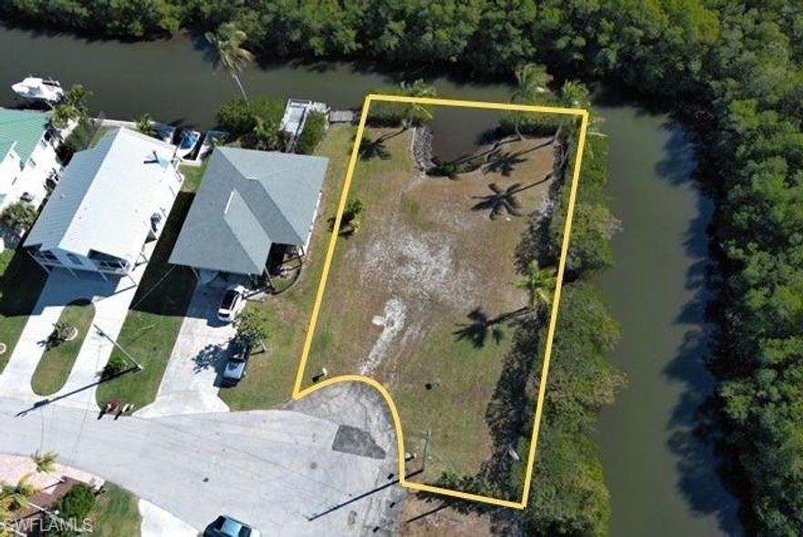 Prime waterfront opportunity in the highly desirable Gulf Harbor community of Naples. This rare corner lot offers 200+ feet of direct Gulf-access water frontage with a quick 15-minute boat ride to Wiggins Pass and the open Gulf of America. The entire parcel enjoys southern exposure, delivering excellent natural light and warmth throughout the day. Ideally positioned for your custom dream home, the property sits only minutes from Wiggins Pass Beach and remains conveniently close to Naples’ finest dining and shopping. With the natural mangrove view to the South and East of the canal this lot combines privacy, immediate water access, and an unbeatable location for those pursuing a true coastal lifestyle.