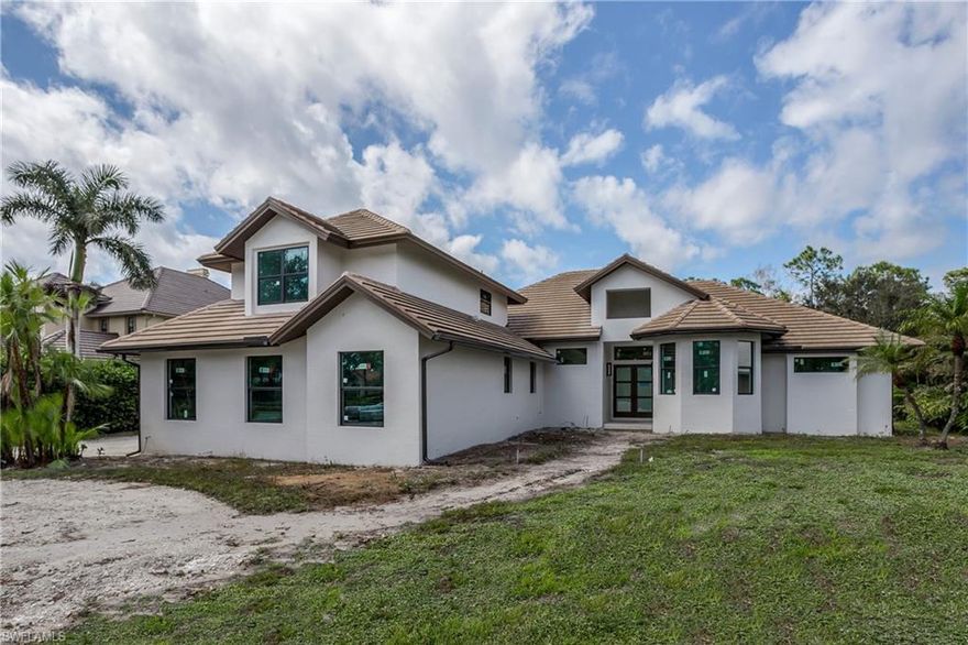 H7372 - Extraordinary design meets exquisite finishes & a prime location. THE LANE. A private gated enclave in the coveted area of North Naples. Western exposure, .89 acre lot surrounded by mature landscaping. This home has been renovated to the stud & rebuilt with today's buyer in mind. The interior includes 5 bedrooms, 4 ½ baths,& a spacious open-concept Dining/Kitchen/Family Room with 12' ceilings. Custom kitchen, with hidden walk-in pantry. Thermador appliance package with 2 dishwashers, double oven, separate 30" refrigerator and freezer towers, 6 burner gas stovetop & wine refrigerator. Beautiful Natural Stone countertops with 2 1/2 inch mitered edge island. The primary bath features multiple shower heads, a separate free-standing tub. Beautiful wood floors throughout. Upstairs "Mother-in-law" suite with kitchenette, separate bedroom, separate living space, bathroom. Exterior Features: New Hurricane Windows and Doors, New pool with oversized water-level hot tub and fire bowls. Extended outdoor lanai under roof with outdoor kitchen. New pavers with circular driveway. New fencing landscaping, Septic & oversized 4.5 garage. Estimated completion end of December.