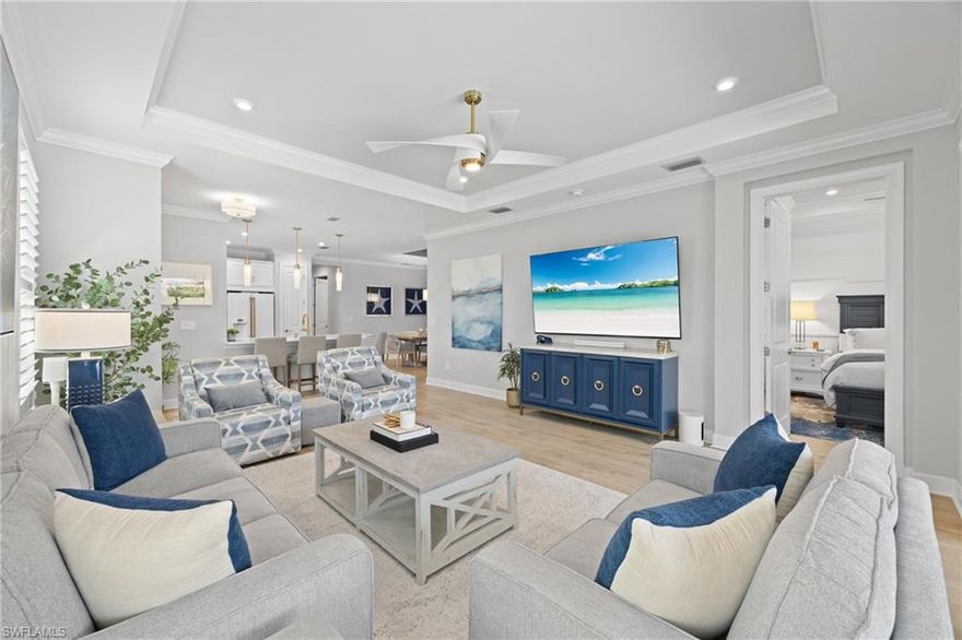 This is the most upgraded Ceretti twin-villa you will find in Esplanade by the Islands — and it isn't close. Nearly every surface, system, and space in this 3-bedroom-plus-den, 1,905 SF home has been thoughtfully enhanced well beyond builder standard. The showpiece is a dramatically expanded lanai enclosed by a panoramic pool cage, creating one of the most impressive outdoor living spaces in the community, complete with a full granite outdoor kitchen, matching granite dining table, and a professionally installed exterior bug misting system — a perimeter-mounted pipe system that sprays a fine mist to keep the outdoor space pest-free at the push of a button. Inside, the owner's suite features a floor-to-ceiling tile shower with a large built-in bench, dual shower heads, custom millwork accent wall, and an additional HVAC vent for year-round comfort. The second bath was upgraded with a double vanity and floor-to-ceiling tiled shower — rare for this floor plan. Elegant finishes carry throughout: plantation shutters on every window, LVP flooring, crown molding, tray ceilings, dining room millwork, touch dimmers, and white café appliances with a farmhouse apron sink in the kitchen. The den has been built out as a true home office with an extensive custom desk, upper and lower cabinetry, and dedicated storage. Every closet in the home has been professionally built out with custom organizer systems including shelving, drawers, and hanging configurations tailored to each space. A whole-home generator, hurricane shutters, alarm system with driveway and entry cameras, central vacuum with kitchen kick vent, EV-ready outlet, and climate-controlled garage with epoxy floor and overhead storage round out the practical upgrades. Esplanade by the Islands is a gated, resort-style Taylor Morrison community off US-41 offering a wellness center and day spa, Bahama Bar & Grille, resort pool, fitness center, tennis, pickleball, bocce, dog park, planned culinary arts center, and a full social calendar. Natural gas community. Minutes to Marco Island beaches and downtown Naples.