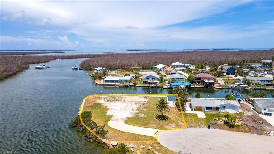 This rare and beautiful oversized .38 Acre Bayfront lot offers breathtaking views and is situated on a canal with a boat well. The previous home has been demolished and removed, which will save you thousands of dollars in impact fees when you build. The lot is in a very desirable area of St. James City and is perfect for building your dream home. Enjoy the peacefulness of the canal and the convenience of having a boat well for easy access to the bay and then to all the boating, beaching, fishing, and visiting waterfront restaurants that Pine Island is known for. The lot is on a point and the south end of the island and offers plenty of privacy. With its stunning views and convenient location, this lot is perfect. Lots like this are rare. This is an exceptional opportunity!