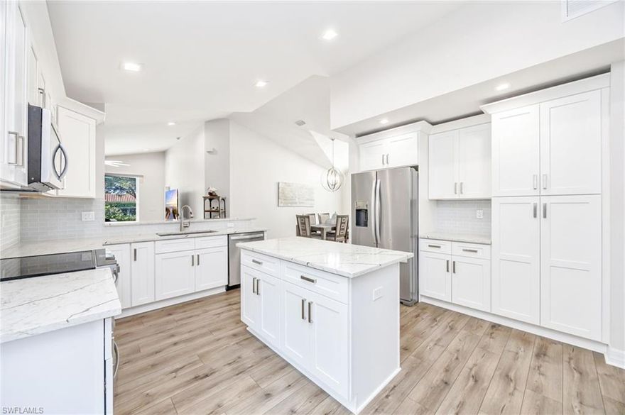 This beautifully updated and upgraded furnished single-family home offers an open Great Room floor plan with vaulted ceilings, creating a bright and inviting living space.  Luxury laminate and upgraded tile flooring flow throughout this 2-bedroom plus den (easily convertible to a 3rd bedroom), 2-bath home with an attached 2-car garage.  Hurricane-impact windows and an alarm/security system provide added protection and peace of mind.  Step outside and enjoy the Naples lifestyle with a newer heated saltwater pool, complete with a raised spa and sun shelf, all perfectly positioned with desirable southern exposure.  Recent upgrades within the past few years include a fully expanded kitchen with center island, quartz countertops, and stainless-steel appliances, including a French door refrigerator.  Both bathrooms have been tastefully renovated with new tile, cabinetry, quartz counters, and upgraded Moen fixtures, including a rain shower.  Additional enhancements include barn doors to the den, updated window treatments and lighting, LED recessed lighting, a newer HVAC system, fresh interior paint, and more.  Residents of Saturnia Lakes enjoy resort-style amenities including a pool and spa, lap pool, kiddie pool, clubhouse, sauna, fitness center, billiards room, tennis courts, basketball, playground, and scenic walking and jogging paths. Ideally located within an A-rated school district and just minutes from shopping, dining, and Naples’ beautiful beaches.