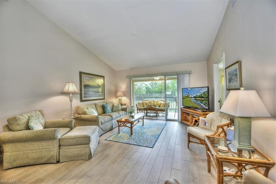Opportunity is knocking - this beautiful condo will be a very comfortable place to call home! Kitchen has been updated with new granite countertops and backsplashes. Gorgeous tiled floors throughout - bedrooms and den have new wood-look tiles. Bright second floor condo with vaulted ceilings, walk-in closet in Master Bedroom, new tile in both bathroom shower enclosures and 1 car garage. Private lanai overlooks small lake and preserve. One of the friendliest communities you will find. Community Center has a fitness room and clubhouse for private parties, 2 tennis courts, 2 pickle ball courts, 2 pools and a play area for children. Community is conveniently located 5 minutes to I-75 and only minutes to Naples Downtown and Beaches. New Tile Roof just completed in January, 2020. Move-in ready - bring your serious buyers, you will be glad you did!