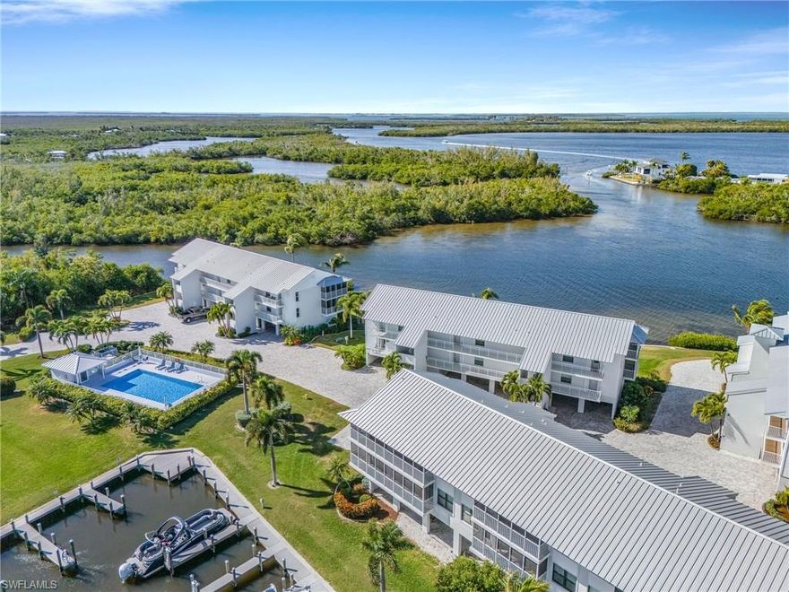 Experience effortless coastal living in this modern and sleek 2-bedroom, 2-bath turnkey penthouse end-unit condo, ideally located in the highly desirable Four Winds Marina community. Soaring vaulted ceilings enhance the open, light-filled layout, while impact-resistant doors and windows provide peace of mind. Enjoy tile and luxury vinyl plank flooring throughout, complemented by beautifully designed, contemporary kitchens and bathrooms. The spacious wraparound screened lanai offers coveted southeast exposure—perfect for relaxing in afternoon shade while still capturing glimpses of stunning sunsets and shimmering water reflections. Just steps away, you’ll find the popular Lazy Flamingo restaurant and world-class fishing charters. Also located a short distance away is Jug Creek Marina & Fish House, where you can enjoy more tasty island food and cath the ferry for amazing tours and adventures. Surrounded by abundant wildlife including dolphins, manatees, wild birds, and schools of fish, this prime waterfront location provides quick boating access to Sanibel, Pine Island, Captiva, Boca Grande, Cayo Costa, and beyond. The solid, secure building features concrete pillars and walls, a durable metal roof installed in 2022, and is complemented by a beautifully updated community with new brick paver driveways, ample parking, and fresh landscaping throughout. Schedule your private showing today and start living the waterfront lifestyle you’ve been dreaming of.