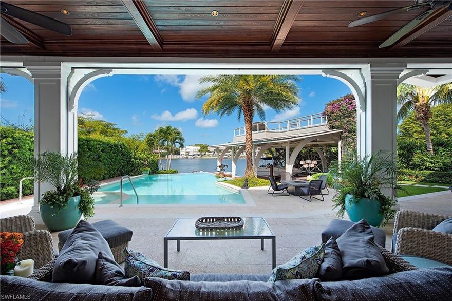 A perfectly positioned custom home offering prime location, views and detailed craftsmanship. With extensive water views over Aqua Cove, this brilliantly created residence lead by Jeff Harrell, Hemmer Construction and Lisa Kahn offers an open plan that evokes indoor-outdoor living. Walnut floors, detailed ceilings, and walls of glass doors create 6,410 square feet of timeless design. The custom kitchen built for entertaining features Thermador and Sub-Zero appliances, clean-lined cabinetry, and quartzite countertops. An elegant master suite with terrace is coupled with a spa-inspired bath featuring Ann Stack mosaic and stone tiles, and a second VIP suite with morning kitchen add to the main level. The secondary levels offer additional guest en-suites, and a custom study outfitted in cherry wood with a shared balcony that guarantees stellar views. The meticulously kept grounds include summer kitchen with Lynx grill, heated pool and spa, custom covered boat slip and an elevated viewing deck perfect for watching the magnificent sunsets. Located in one of Naples’ most coveted locations, this exceptional home offers close proximity to the beach and the amenities of Third Street South.