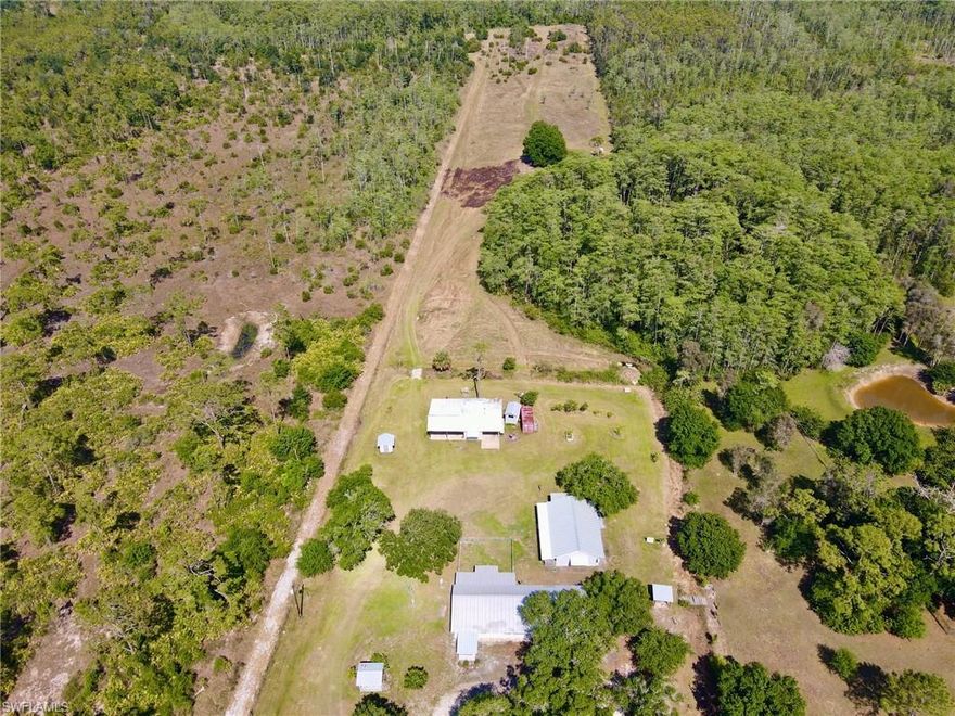 BACK ON MARKET due to buyer financing. Get the best of both worlds with this amazing 10 acre property. The perfect opportunity to live the country lifestyle away from it all, on the outskirts of Fort Myers yet only 20 minutes from modern conveniences such as I-75 access and the Gateway area. From the moment you arrive, you will be welcomed by the most beautiful trees and massive acreage. Make way to the main house boasting 3 bedrooms, 2 bathrooms, 2 dens and a screened-in porch perfect for those early morning cups of coffee. There is plenty of space for the guests in the quaint 1 bedroom, 1 bathroom guest house located behind the main home. Spend a few minutes picking fresh papaya, key lime, mango, guava and more from the variety of fruit trees located on property before heading to the workshop or the property's private gun range. The property also features a pole barn with storage, sheds, a gazebo, a new AC and an upgraded 125 foot deep well. Call today to tour this private, countryside retreat!