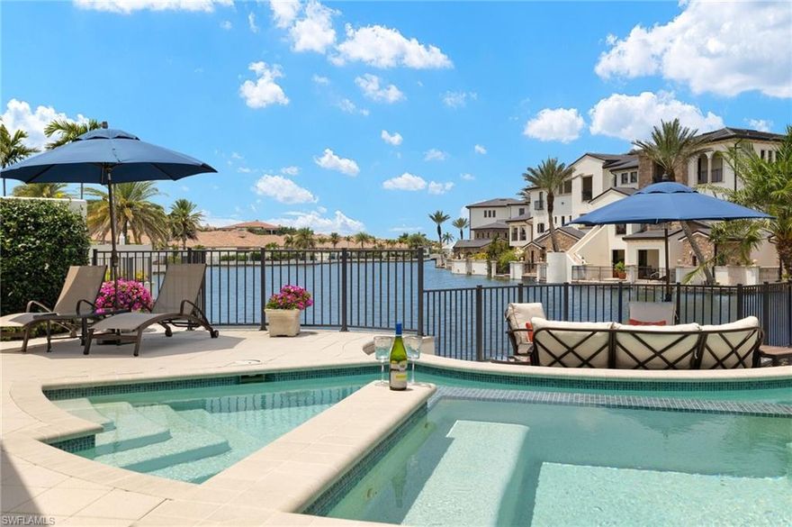 IMMEDIATE GOLF MEMBERSHIP AVAILABLE FOR PURCHASE AT CLOSING! SKIP THE WAITLIST! GOLF CART INCLUDED! Sun-drenched long lake views and gorgeous sunsets over the iconic bridge, plus a timeless interior, combine to make this one-owner custom-built residence in TALIS PARK a show stopper!  From the moment you enter the foyer, you'll be delighted with the many upgrades, including beautiful soft, white cabinetry. An expansive island, a separate bar with a wine cooler and plenty of cabinets for storage, stunning light fixtures, a vaulted beamed ceiling and an office with built in cabinetry and two desks could easily serve as a fourth bedroom.  A spacious primary suite affords two walk-in closets, an oversized shower and stunning vistas. The split bedroom floor plan on the second level provides two spacious ensuite bedrooms and a large loft area for an engaging gathering place for tv watching or to seek solitude while working/reading.  The summer kitchen provides a beautiful setting for entertaining or al fresco dining.  Electric screens make it pleasant year round. The pool and spa area have an exquisite California vibe plus an exceptional terraced area for enjoying the gorgeous views. Even the garage is well equipped with a Daikin room air conditioner, parking for two vehicles plus a golf cart, EV charging station, built in shelving and an epoxy floor.  With an easy stroll across the street to the driving range and Casa Cortese, this location is highly desirable.  Talis Park features an award winning golf course designed by Greg Norman and Pete Dye, an award winning clubhouse with numerous dining/bar venues, the Casa Cortese with a golf simulator and billiards, Fiona's Market, workout facilities, Esprit Spa, tennis, pickleball, bocce, two dog parks, miles of walking/running/bike riding and an extremely busy social calendar.  Located between Olde Naples and RSW Airport and a short drive to the sandy beaches of Naples, the location is premier.  Time to live your very best life in Talis Park!