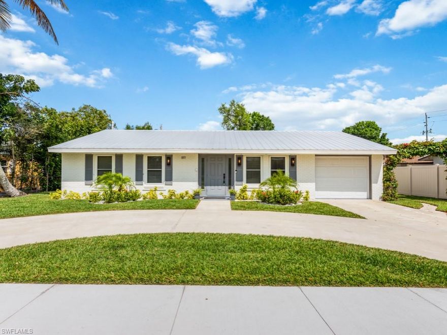 Centrally located 3 Bedroom, 2 Bath home on a generous sized, fully fenced 0.24 acre lot. Wonderful curb appeal with white painted brick facade, grey shutters and door with side light windows. A circular driveway and 1 car garage provides plenty of parking.  Fantastic features include a 2022 renovated kitchen with stainless whirlpool appliances and granite countertop, updated bathrooms, insulated glass windows, whole house re-plumbed in 2022, and new hot water heater.  Indoor laundry room has floor to ceiling cabinetry plus a tool shed and storage shed in the back for plenty of storage.  This home offers a screened in lanai and an uncovered paver deck overlooking an expansive back yard and allows room to add a pool. This prime location is minutes to so many local attractions, restaurants, schools, parks and of course Naples famous beaches.  Located in an x-500 zone.