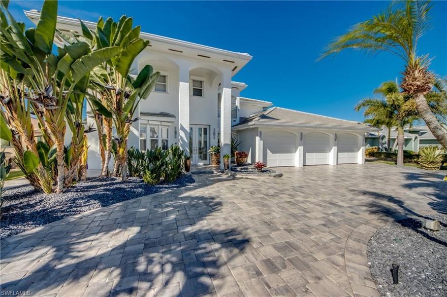 Completely remodeled and move-in ready, this stunning two-story direct Gulf access home sits on a prime intersection of canals in the highly desirable Palaco Grande neighborhood. With western rear exposure, you’ll enjoy spectacular sunset views every evening and a quick 2-minute boat ride to the Caloosahatchee River.

Offering over 3,600 square feet of living space, the home was designed around open, airy waterfront living. The high-end kitchen is the heart of the home, featuring built-in KitchenAid appliances, a 36-inch cooktop, built-in fridge, and beautiful exotic granite. Water views from both the kitchen and living room create a seamless connection to the outdoors and make entertaining effortless.

The first floor includes three spacious bedrooms with engineered wood flooring, plus a large family room currently set up as a game room. A stylish bar area with wine cooler and beverage center adds the perfect touch for hosting friends and family. Dual AC systems (2020) and a wired surround sound system in the living area and lanai provide comfort and ambiance throughout.

Upstairs feels like a private retreat, with a loft, oversized balcony, and an impressive master suite. The spa-like bathroom features a freestanding tub, double vanities with makeup area, custom cabinetry, chandelier lighting, and a walk-in shower with multiple shower heads. A huge walk-in closet completes the space.

Step outside and the home truly shines. The heated pool (electric and solar) is surrounded by a large paved deck and lanai with plenty of room to relax. The picture-window cage with super screen keeps views wide open, while sealed pavers extend beyond the enclosure. Lush tropical landscaping — including Sylvester palms and screw palms — paired with landscape lighting creates a beautiful evening atmosphere.

For boaters, the dock is exceptional: PVC decking, captain’s walk, stainless steel rigging, solar piling cap lights, and a 16,000 lb lift with canopy. A new seawall was installed in 2019 during the renovation. Even better, the owner’s flood policy is assumable at just $2,600 per year.

This home combines modern updates, unbeatable boating access, and resort-style outdoor living — a true waterfront lifestyle property.