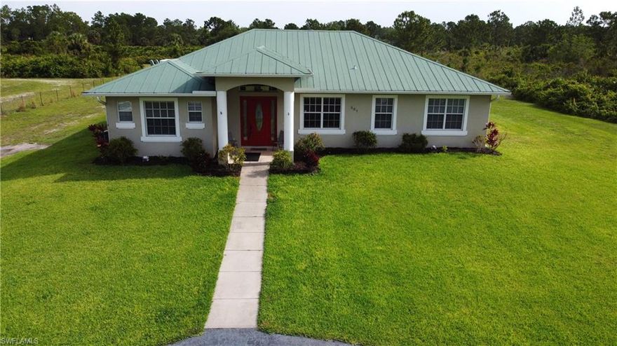 It’s all about the location! Welcome to this beautiful property situated on a 2.27 acre lot. This home offers a charming & well maintained 1 story ranch located just off Randall Blvd (less than 2 miles from Publix). With a generous living area of 2,800+ square feet, this home provides ample space for comfortable living.  The interior features 4 bedrooms, perfect for accommodating a growing family or hosting guests, along with an oversized media room, den, home office or study. Additionally, there are 3 full baths ensuring convenience & privacy for everyone. The property further boasts an array of desirable features, one being the kitchen showcasing all new LG stainless steel appliances, 2 a/c units, (one unit 5 months old), 2 water heaters (1 tankless), & front gate & fenced in yard. A delightful screened in porch offers a serene space for relaxation and a peaceful and secluded environment while still being in close proximity to Naples’ vibrant amenities. This prime location allows for a harmonious blend of country living with easy access to pristine beaches, upscale shopping, renowned golf courses & fine dining options.