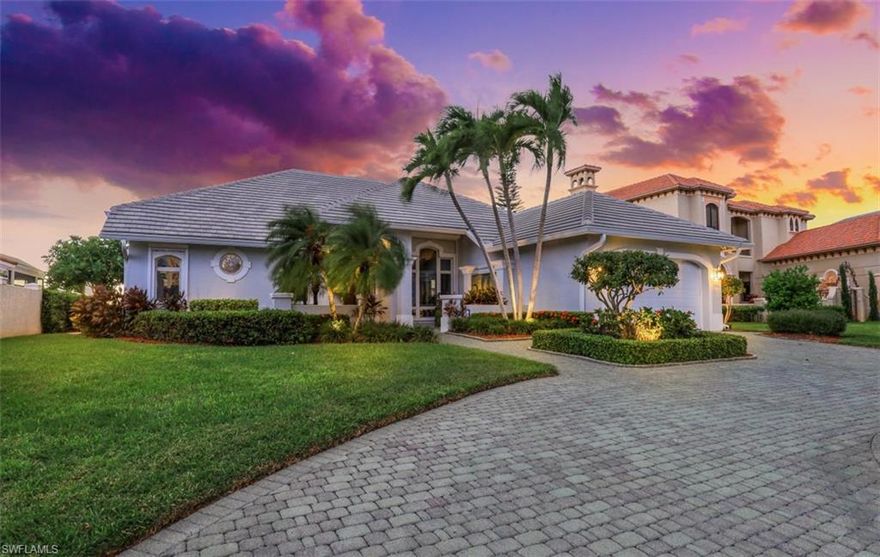 Experience stunning  sunsets and endless bay views 3,500 ft wide (and Yacht traffic) from this furnished, turnkey 3 Bed + Den | 3 Bath contemporary coastal home. Designed for Florida's indoor/outdoor lifestyle, this open plan residence is tucked away on a private cul-de-sac with a circular drive and delightful entry fountain. Inside, you'll find a spacious great room, formal dining, Bosch-equipped kitchen, breakfast nook, snack bar, den, all with captivating bay views. The primary ensuite offers roomy privacy and a spacious ensuite bath, while two bedrooms share their own bath.  2-car garage with storage shelves and a workshop. Relax on the covered lanai with a screened pool, waterfall spa, and a summer kitchen with grill. Boaters will love the quick access and newer dock with a new22,000 lb lift and double jet ski lift. Electric storm shutters provide comfort and convenience. In a prime location near Rose Marina, the charming Old Marco shops, and the excitement of Collier Boulevard shopping and dining. Roof replaced in 2018. An ideal family home or income opportunity in the sought-after neighborhood featuring unparalleled sunsets over wide water of Collier Bay.