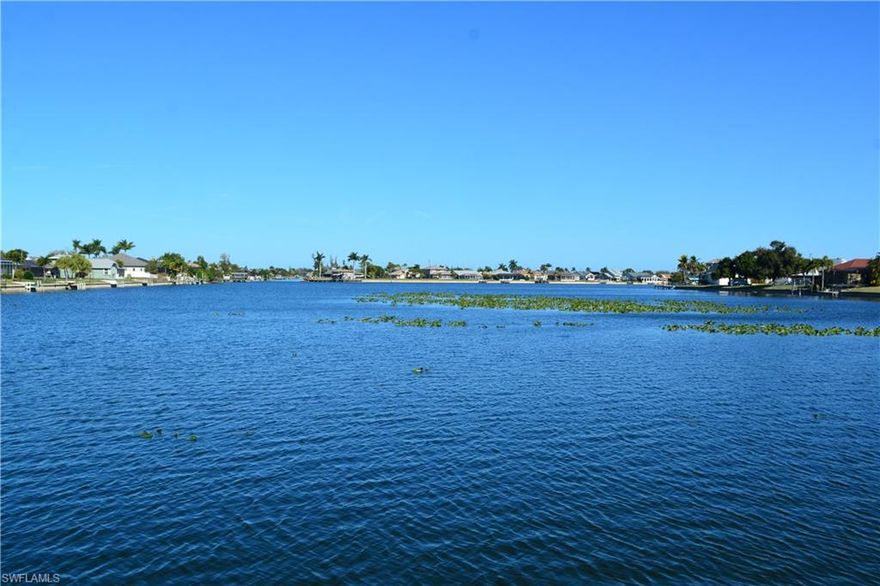 Welcome to an exceptional opportunity to build your custom dream home on the highly desirable South Shore of Lake Alhambra. This premier waterfront homesite offers breathtaking panoramic lake views and direct access to miles of navigable waterways, placing you at the heart of Cape Coral’s renowned chain-of-lakes system.

From your backyard, set sail through interconnected waterways that lead to Lake Kennedy, Lake Saratoga, Shamrock Lake, and numerous other lakes—perfect for boating, kayaking, fishing, and sunset cruises. Whether you’re an avid boater or simply enjoy tranquil waterfront living, this location delivers the ideal balance of recreation and relaxation.

Nature lovers will appreciate the daily wildlife encounters, from osprey diving for fish to playful otters and graceful turtles gliding through the water, creating a serene and picturesque setting right outside your door.

Adding to the value, all assessments are fully paid, offering peace of mind and simplifying the path to construction. Ideally situated, this property provides quick access to Cape Coral’s top dining, shopping, entertainment, and outdoor recreation, while still maintaining a quiet, residential feel.

Opportunities like this are rare—secure your place on one of Cape Coral’s most sought-after lakefront locations and start envisioning the waterfront lifestyle you’ve been dreaming of. Don’t wait—this one won’t last.