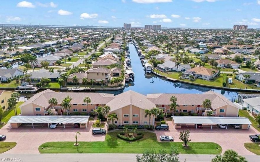 LOOK NO FURTHER! This beautiful, low priced GULF ACCESS (No Bridges) condo has everything you could want plus a few extras! Only seasonally used by the owners, this unit is in impeccable shape. Includes QUALITY FURNISHINGS and sold TURNKEY! *FIRST FLOOR convenience, walk right out to the pool (SOUTHERN EXPOSURE keeps sun on the pool deck and warmth all year long), and a view down INTERSECTING CANALS, it's almost to good to be true! *LARGE screened lanai (most condos have a lanai only half this size) with removeable LEXAN tinted sliding doors *Tastefully remodeled unit including: BRAND NEW KITCHEN (Shaker style Cabinets w/ soft close hinges, granite counter tops, and all NEW appliances. BRAND NEW MASTER BATHROOM (Tiled walls w/ waterfall affect, glass shower enclosure, large closet, vanity and sink. *NEW Air Conditioning *IMPACT RESISTANT WINDOWS *Spacious laundry/utility room in the unit with stackable washer/dryer and counter for folding clothes *Tons of natural light throughout the unit *The building is like a TANK, completely CONCRETE including floor between 1st and second levels (which also helps reduce any noise and keeps energy costs incredibly LOW - this unit averages $40/month electrical bill, WOW! *Plenty of dock space available to tie up your boat (unrestricted access out to the river). *ADDITIONAL EXTERIOR STORAGE CLOSET included with the condo. Also, a CARPORT to keep your vehicle protected from the elements. Your PET is welcome here (with some exclusions). This condo would also make a WONDERFUL RENTAL generating a nice stream of income. It is a must see and you WON'T BE DISAPPOINTED!
