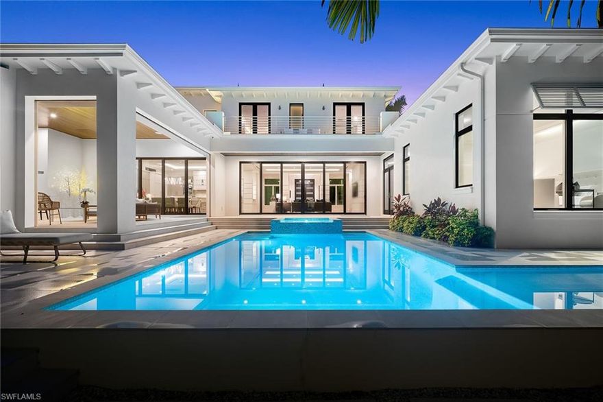 This 2020 architectural masterpiece by Gulfstream Homes, Kukk Architecture and Koastal Design Group is both modern and inviting. Tiered waterfalls and a grand mahogany front door welcome you into this ethereal home with floating cloud ceilings and recessed soffits, European wood flooring and quality finishes throughout. A great room with elegant architectural columns and a gourmet kitchen overlook the expansive outdoor living area with an outdoor kitchen, gas fireplace, television, and motorized screens and shutters. Lounge at the tranquil saltwater pool with large sun shelf and luxurious spa, and then rinse off in the true outdoor shower. Retreat to the serene primary suite with sitting area, incredible closet and luxurious bathroom. One additional en-suite bedroom on the first floor and two en-suite bedrooms and an en-suite loft/den that could be converted to another bedroom complete the home. Additional features include a Control4 smart home system, three-car tandem garage with lift, 1,000-gallon propane tank, whole house generator and more. Offered furnished with exclusions. The Moorings is a premier Naples location with opportunity to join the Moorings Resident Beach Club.