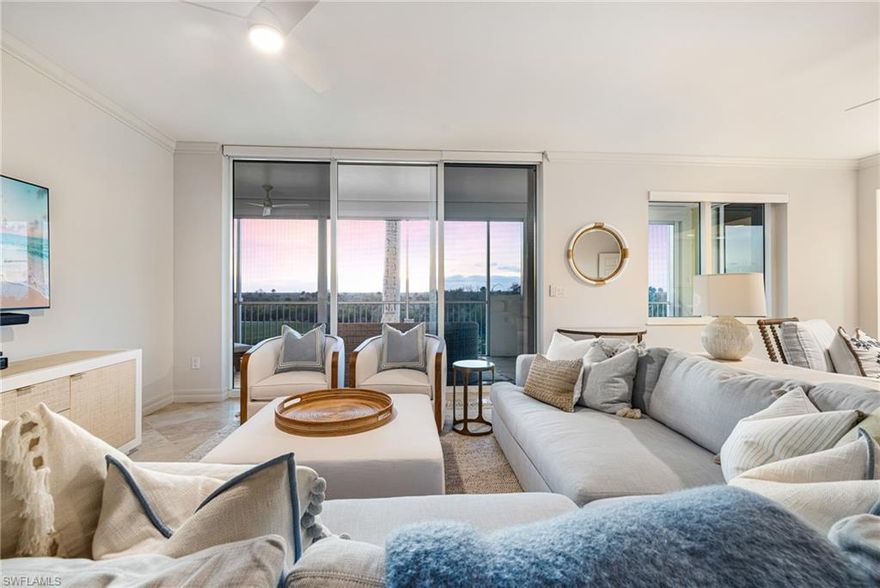 Set high above the treetops, this impressive 2nd-floor condo showcases sweeping lake and golf course panoramas and includes a PRIVATE COURTYARD available only on select 2nd-floor layouts, creating a rare outdoor retreat that sets this residence apart. An additional lanai on the east side of the building welcomes soft morning light and offers the perfect spot for coffee, reading, or easing into the day, while vibrant sunset skies over West Bay Club’s signature 9th hole bring stunning evenings at home. Inside, the expansive great-room design flows effortlessly into the open kitchen, making entertaining both easy and elegant. Each of the three spacious bedrooms features its own en-suite bath, and the large laundry room adds excellent storage and everyday convenience. The home is thoughtfully upgraded with Quartz counters, new carpet in the primary suite, upgraded light fixtures and fans, electric sunshades throughout, new memory foam mattresses, roll-down hurricane shutters, all new furniture, luxurious window treatments, crown molding, marble and travertine flooring—including travertine in a guest bedroom—and custom closets, along with private elevator access directly to the residence. Offered TURNKEY FURNISHED, it is move-in ready for effortless seasonal or full-time enjoyment. Jasmine Bay residents enjoy an infinity-edge pool, hot tub, private cabanas, grilling stations, club room, card room, movie theater, and a fully equipped fitness center, plus four on-site guest suites ideal for hosting visitors. West Bay Club further elevates the lifestyle with its beautifully remodeled 2024 Gulf-front Beach Club featuring full-service dining, towel and chair service, and direct beach access. Additional amenities include the Bay House with resort-style pool and Aqua Café for indoor or poolside dining, plus yoga, Pilates, spinning rooms, sauna, Technogym fitness center, and 8 Har-Tru tennis courts. River Park provides a kayak and boat launch with direct Gulf access, fishing pier, playground, basketball court, picnic areas, and a serene 1.5-mile nature trail, while the Sports Park offers 6 pickleball courts, bocce, a fitness lawn, and two dog parks. Optional membership is available for the private Pete and P.B. Dye championship golf course and clubhouse, and the community’s ideal location places you minutes from Coconut Point, Miromar Outlets, Hertz Arena, and SWFL International Airport.