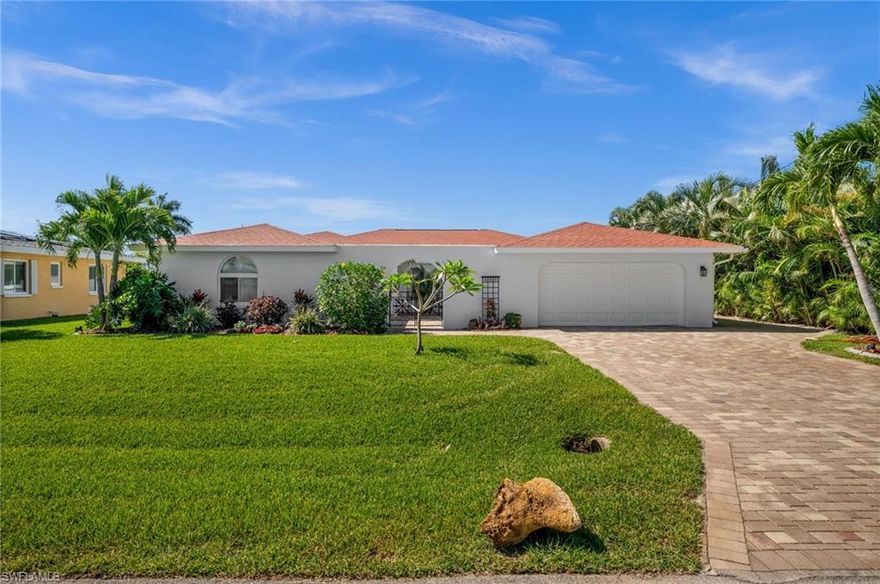 Experience elevated waterfront living in this fully remodeled Gulf-access residence located in the desirable Yacht Club area of Cape Coral. Offering approximately 2,780 square feet, this move-in-ready home features 5 bedrooms, 3 full bathrooms, and thoughtfully designed indoor and outdoor living spaces with upscale finishes throughout. The open-concept floor plan is centered around a spacious chef-inspired kitchen featuring a large island, premium mitered-edge quartz countertops, and high-end Bosch appliances including an electric cooktop, hood vent, microwave, double oven, and dishwasher. Matching quartz surfaces continue throughout all bathrooms for a cohesive and modern design aesthetic. The primary suite includes a Kohler digital steam shower system designed for a spa-like experience. Multiple living and dining areas provide flexibility for entertaining, gatherings, or everyday living. Outdoor features include a screened lanai with an in-ground heated pool and 2-person hot tub overlooking the canal, along with an additional open waterfront patio area ideal for enjoying the Florida lifestyle. The private dock includes a boatlift plus water and electric service. Gulf access canal connectivity provides convenient boating opportunities throughout Southwest Florida.Additional highlights include a newer roof, two newer A/C systems, a gated front courtyard with tropical landscaping and seating areas, a 2-carattached garage, and extensive updates throughout the property. Conveniently located near shopping, dining, entertainment, and waterfront attractions, this remodeled Cape Coral home combines modern luxury, boating access, and exceptional outdoor living in one of the area’s sought-after waterfront neighborhoods.