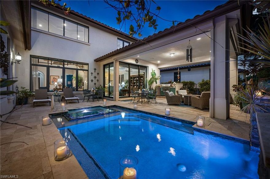 An exceptional opportunity awaits in Grey Oaks Country Club, one of Naples’ most desirable golf communities, where IMMEDIATE GOLF MEMBERSHIP IS AVAILABLE with this residence. Ideally located within the Traditions neighborhood, this gracious two-story home offers timeless design, thoughtful upgrades, and an easy, elegant lifestyle. 

Built in 2013, the residence spans approximately 4,500 square feet and features four bedrooms plus a private office, four full and one half baths, and a private elevator—an uncommon and highly desirable feature within Traditions. Light marble floors extend throughout the main living areas, while high ceilings and generous millwork create an airy, refined interior filled with natural light.

The kitchen is both beautiful and highly functional, appointed with custom cabinetry offering abundant storage and a complete suite of JennAir appliances, including a gas range, wall double ovens, microwave, dishwasher, and refrigerator. Open to the family and living rooms, the layout encourages connection and comfort, with elegant moldings, custom built-ins, and open sightlines ideal for everyday living and entertaining.
The primary suite is a peaceful retreat, featuring French doors opening directly to the pool and spa, large walk-in closets, plantation shutters, and a well-appointed bath with custom cabinetry and dual vanities. Upstairs, three generously sized guest suites provide privacy and comfort, including one with access to a private balcony. A versatile loft with wood flooring, custom built-ins, and a built-in bar with under-counter refrigerator offers flexible living space and may be enclosed to create a fifth bedroom or playroom, if desired.
Outdoor living is designed for year-round enjoyment, featuring a redesigned pool and spa, summer kitchen with built-in gas grill, wood ceiling detail, automated hurricane screens, and a very private backyard—perfect for entertaining or quiet moments of relaxation.

Additional highlights include a whole-house generator, automated sunshades in the main living areas, impact windows and doors, central vacuum system, tankless gas water heater, and three air-conditioning units, two replaced in 2024. The property also offers a two-car garage plus a separate golf cart garage, all finished with epoxy flooring, new hurricane-rated garage doors, a removed center post, and added overhead storage. Traditions is a natural-gas community.

Residents enjoy access to three championship golf courses, two clubhouses, resort-style pool, tennis and pickleball courts, a state-of-the-art wellness center, and multiple dining venues—all within a beautifully landscaped, guard-gated setting just minutes from Naples’ beaches, shopping, and dining.
This is a rare opportunity to enjoy immediate golf membership and a meticulously maintained home in one of Grey Oaks’ most established and welcoming neighborhoods—where comfort, quality, and lifestyle come together effortlessly. Welcome home.