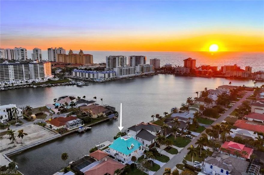 Exceptional Gulf access waterfront residence offering sweeping southern canal vistas and bay views, gorgeous by day or night to enjoys the lights of the Ritz. Beautifully renovated rare coastal find! From the moment you arrive, elegant mahogany double entry doors frame a stunning sightline to the shimmering water views beyond. This meticulously maintained three story home with elevator has been masterfully reimagined with a refined open-concept design, ideal for both relaxed living and elevated entertaining. The great room is anchored by a sleek linear fireplace that sets the mood, seamlessly flowing into a chef inspired kitchen featuring wine cooler and custom built-in banquette wrapped in dramatic mitered windows an unforgettable gathering space. Contemporary glass railed stairs lead to a private loft and the serene primary suite, highlighted by a tray ceiling, dual custom closets, and a spa-like oversized bath. Step onto your private balcony and savor breathtaking sunsets and the lights at night of the Ritz. Terraces on all three levels provide remarkable outdoor living spaces. Designed for effortless indoor outdoor living boasting the first-floor spacious family room/media area with dining that opens to a private resort style pool and spa, complete with a pizza oven and outdoor kitchen ambiance. Perfect for hosting or unwinding after a day on the water, while a solid composite dock with boat lift ensures easy care and access to the Gulf. Additional features include a 3+ car garage. Just a short stroll to the white sugar sands of Vanderbilt Beach and moments from world class dining at the Ritz, plethora of upscale shopping, La Playa Beach Club, Mercato shopping and entertainment. One visit is all it takes to fall in love!