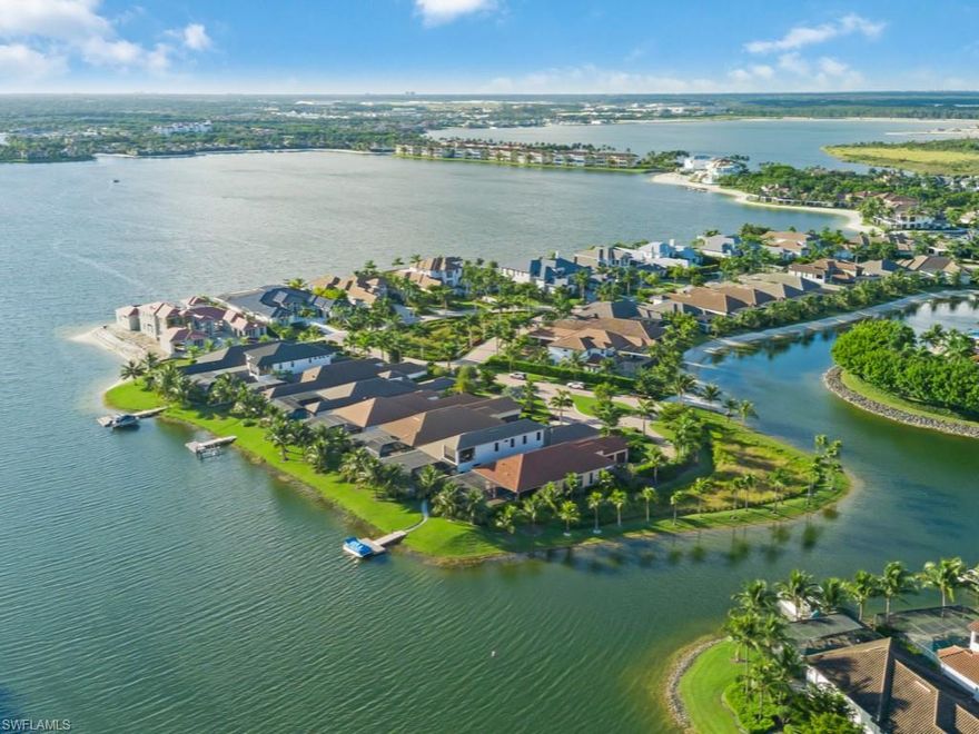 Immaculate one-of-a-kind custom waterfront home with refined architectural detail, high-end designer elements, four-car garage, and more! Offered FURNISHED for buyer with an appreciation for quality Legno Bastone wide-plank wood flooring, fine Italian and Scandinavian furnishings, custom lighting, closets and cabinetry, and curated interior design. Nearly 3900 square feet under air, 4-bedroom, 3 full and 2 half baths plus BONUS OR 5TH BEDROOM with sunset balcony. Great room seamlessly flows to outdoor living room with gas fireplace, dining, pool bath and outdoor kitchen with refrigerator, dishwasher, gas grill and cooktop. The custom black Pebble Tec-finish pool with integrated spa, sun-shelf and water feature overlooks Miromar's 700 acre freshwater lake. Customize a backyard boat dock after purchase. Full-home automation: lighting, audio, full house hurricane shutters, and motorized window coverings. The tiled air-conditioned 4-car garage is a collector's dream, with charging areas, custom white powder-coated garage-doors and motion sensor lighting. Enjoy Miromar Lakes’ beaches, boating and the Luxury Resort Lifestyle of #1 Community in the United States.