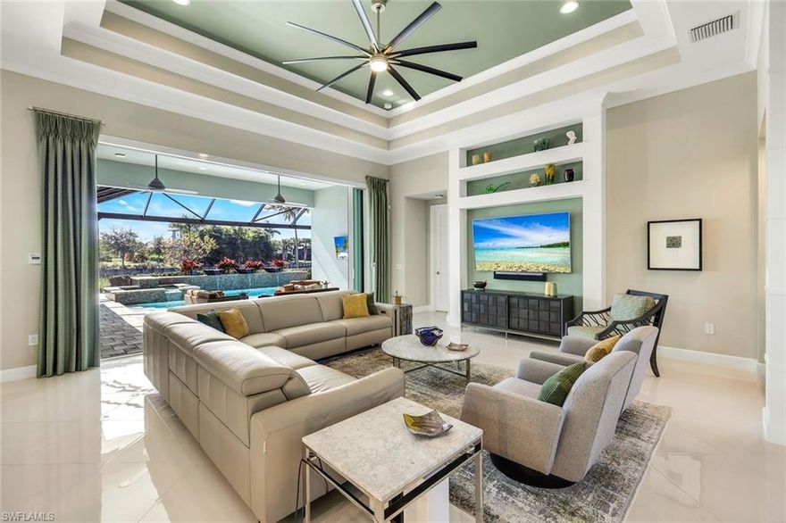 Experience effortless modern luxury in this impeccably maintained, turnkey residence offering serene southern lake views and refined architectural design in Isles of Collier Preserve. With approximately 3,054 square feet under air, this home delivers a rare blend of elegance, comfort, and resort-style living—ideal for both full-time residents and sophisticated seasonal buyers.
Soaring ceilings and expansive living spaces define the light-filled interior, where an open-concept great room flows seamlessly into the dining area and gourmet kitchen. Polished 24-inch ceramic tile flooring enhances the clean, modern aesthetic, while designer finishes and curated furnishings create a home that feels both polished and inviting. Wide pocketing sliders reinforce the seamless connection between indoor and outdoor living.
The chef’s kitchen is thoughtfully appointed with premium Thermador appliances, complemented by a GE Monogram induction cooktop, modern cabinetry, generous prep space, and a substantial center island with seating—perfect for entertaining and everyday living. A versatile flex room adds functional appeal, ideal as a study, media room, or additional lounge space.
Outdoor living is a true highlight. The expansive screened lanai showcases a spectacular saltwater pool and raised spa set against tranquil lake views, enhanced by coveted southern exposure that provides all-day sun on the lanai. All pool equipment has been newly updated in 2025, and a fully equipped outdoor kitchen with bar seating creates an inviting setting for dining, relaxing, and entertaining year-round.
The primary suite offers a private retreat with peaceful lake views framed by large windows and a spa-inspired bath. Two additional guest bedrooms are thoughtfully separated for privacy, each featuring its own ensuite bathroom—ideal for hosting family and guests.
Additional highlights include hurricane-impact windows and doors, a split three-car garage, new Samsung washer and dryer (2025), and a whole-home Generac generator system installed in 2024 with in-ground propane tank for worry-free power backup. Residents enjoy a resort-style lifestyle just minutes from downtown Naples, the Bayshore Arts District, Fifth Avenue South, and the Gulf beaches.