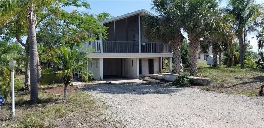 2 bedroom 2 bath with a screened in balcony which has recently been painted on the inside.  Tile floors throughout and kitchen appliances including the washer and dryer.  There is potential to add living space on the bottom which is currently a carport and garage.  Located on a dead end street with lots of privacy.  Call for your private showing today!